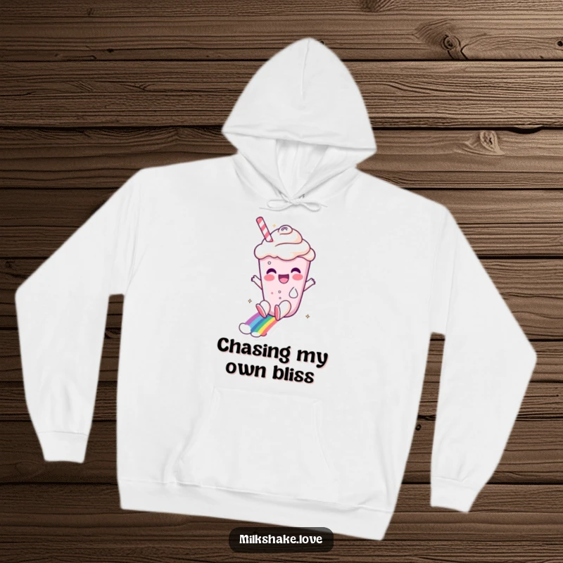Funny milkshake character sliding down a rainbow, depicted on a cozy hoodie, offering warmth and whimsical charm.
