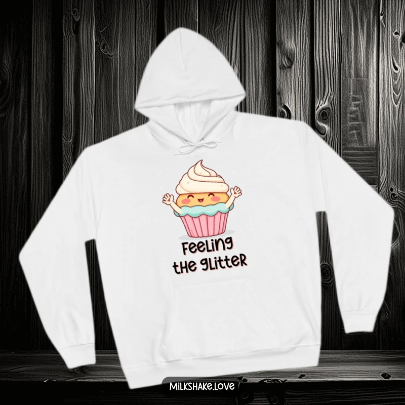 Funny hoodie featuring a blushing cupcake with small waving arms, enthusiastically greeting sparkles, offering cozy comfort.