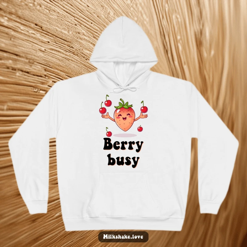Funny Juggling Strawberry Hoodie: A smiling strawberry with arms outstretched joyfully juggling cherries, soft and cozy.
