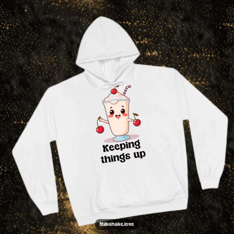 Funny Hoodie featuring a happy kawaii milkshake juggling three tiny cherries, radiating playful skill and warmth.