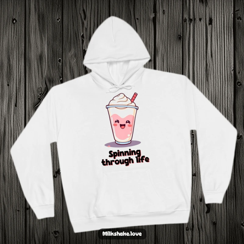 Funny smiling milkshake cup doing a cheerful spin, printed on a soft hoodie for cozy sweetness.