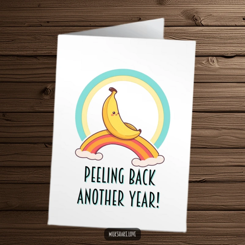 Funny Free Printable Birthday Card: A smiling banana character joyfully sliding down a vibrant rainbow, full of festive cheer.